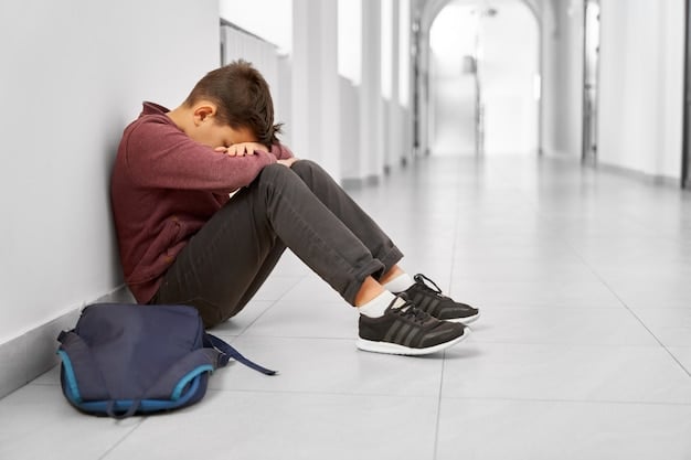 A Young Boy Sitting Alone in a Hallway